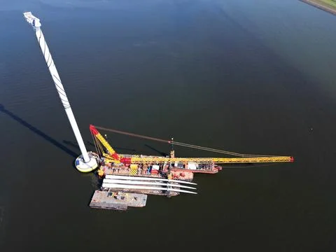 A transport ship and crane for constructing an offshore windpark Stock Photos