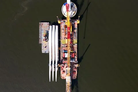 A transport ship and crane for constructing an offshore windpark Stock Photos