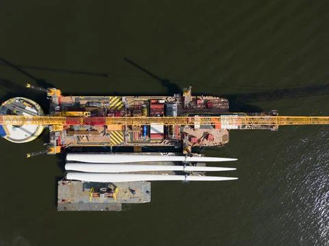 A transport ship and crane for constructing an offshore windpark Stock Photos