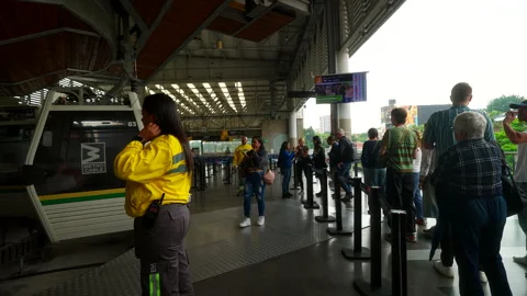 Transport Staff Managing Passenger Queue for Urban Cable Car System Stock Footage 333815071