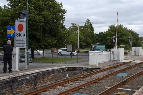 A Transport for Wales train driver operating level crossing equipment Stock Photos