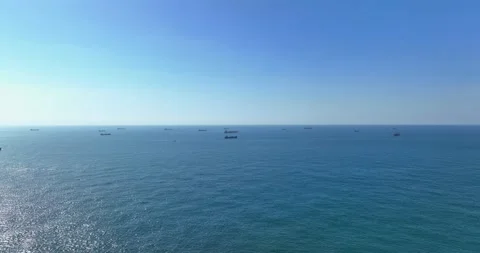 Transportation and Container ships wait on the ocean in front of the port of Stock Footage 227922266