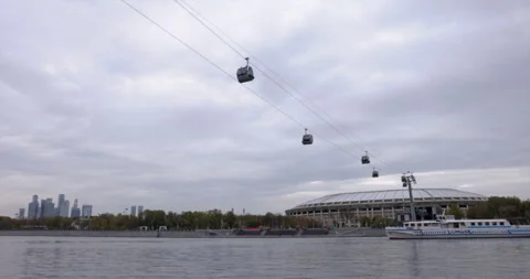Transportation over River: Cableway Flying Above Moscow Stadium and Cloudy Sky Vidéo 253114045