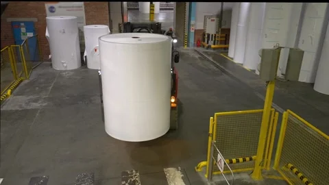 Transportation of paper in rolls by a warehouse loader to a warehouse 스톡 동영상 321863811