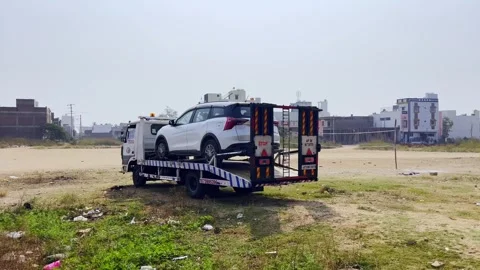 Transporting disabled vehicle through green countryside Stock Footage 332423594