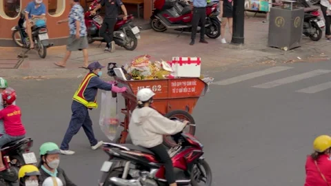 Transporting garbage in a handcart through the streets of Vietnam Video stock 239406187