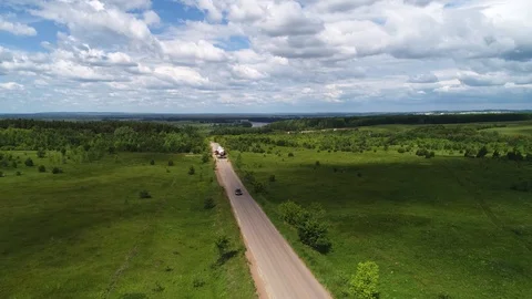 Transporting a large pipe / reactor on a road through a green valley. Stock Footage 124245254