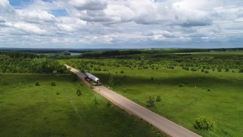Transporting a large pipe / reactor on a road through a green valley. Stock Footage 124245287