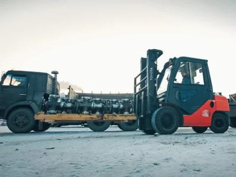 Transporting oil catches on loader. Stock Photos