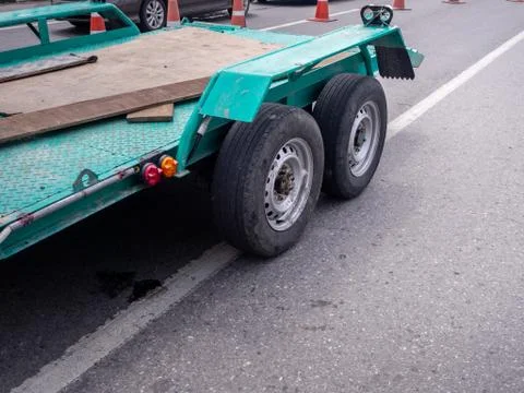 Transporting small  cargo trailer for a car strapped Stock Photos