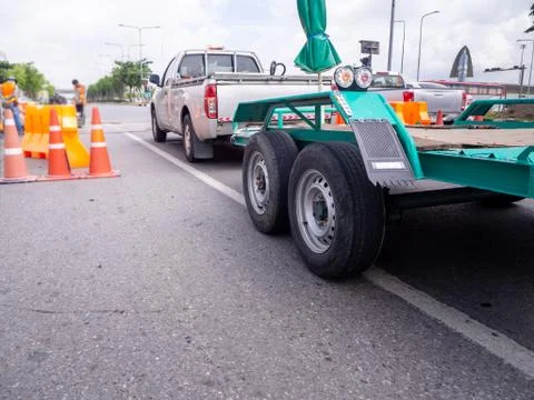 Transporting small  cargo trailer for a car strapped 写真素材