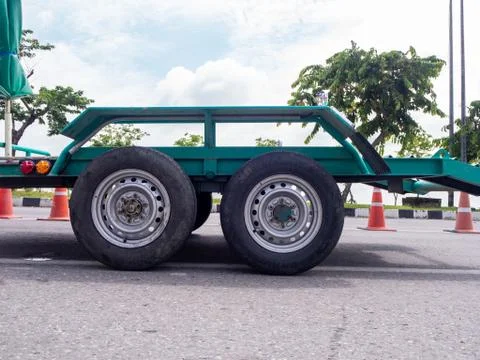 Transporting small  cargo trailer for a car strapped Stock Photos