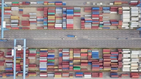 Transtainer yard - Shipping containers stacked by large cranes. Stock Footage 101660136