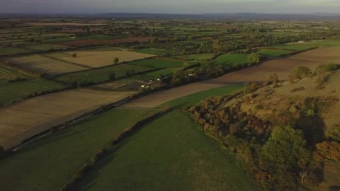 Transverse reveal of the patchwork of fields, UK in the evening Video stock 218470787
