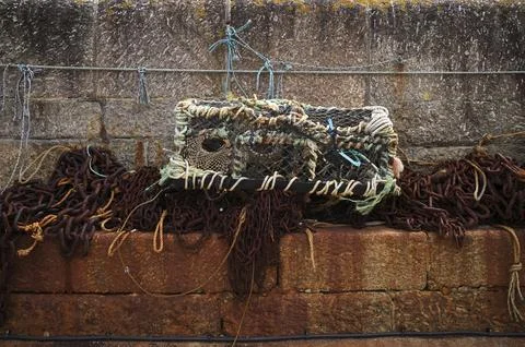 Trap, rust, rusted chains, pier, quay wall, harbor. St Ives, Cornwall, England, Stock Photos