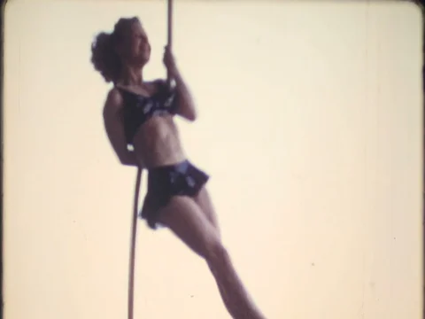 Trapeze artist performs acrobatics on rope1950s vintage home movie 4074 Stock Footage