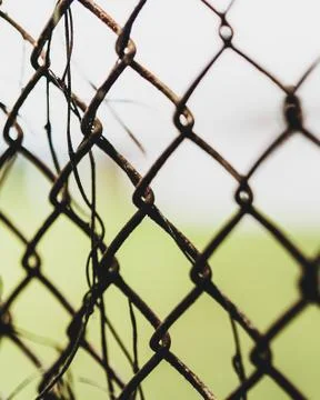 Trapped behind a rusty chain link fence Stockfoto's