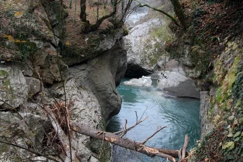 Trapped tree trunks hang over the water in the Khadzhokhskaya gorge. Stock Photos