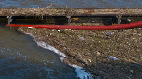 Trapping debris in polluted water Stock Footage 308798104