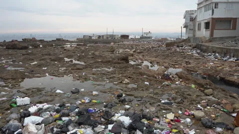 Trash and Garbage in Front of Abandoned Buildings on Coast of Syria Stock Footage 314719408