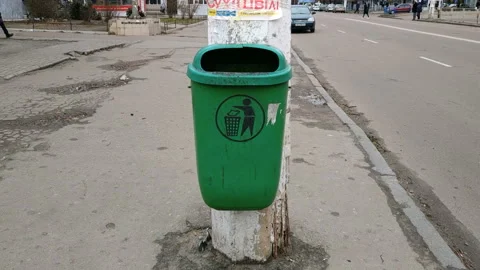 Trash bag in a concrete bin mounted on a pedestrian pavement Stock Footage 113358018