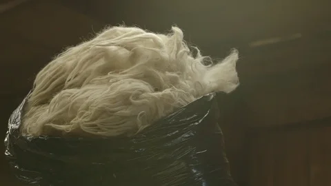 Trash bag filled with sheep wool Stock Footage 83864730