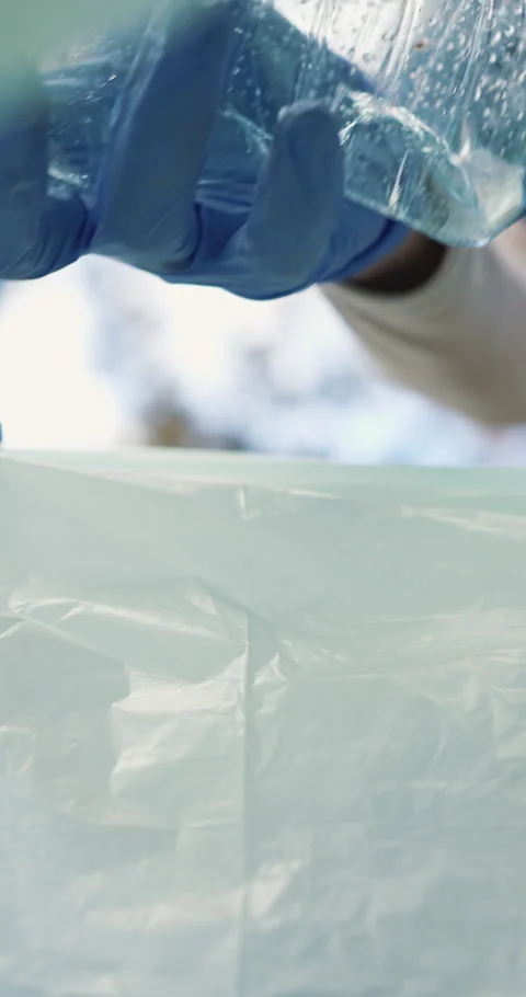 Trash bag, plastic and hands of volunteer for recycling, sustainability or Stock Footage 334024293