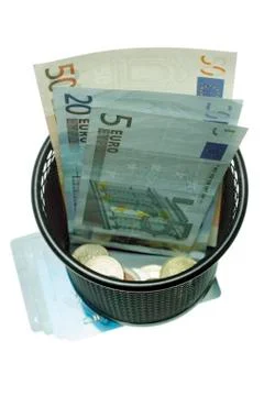Trash with banknotes as metaphor Stock Photos