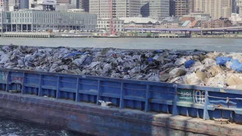 Trash barge transporting solid waste on East river in New York, USA Stock Footage 199243910