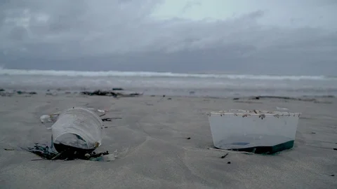 Trash on the beach, plastic in the background the ocean Stock Footage 126973783