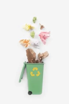 Trash bin and paper garbage on white background, top view Stock Photos
