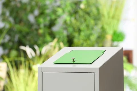 Trash bin on blurred background, space for text. Recycling problem Stock Photos