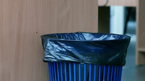 Trash bin close-up into which the spoiled office paper falls Stock Footage 137948731