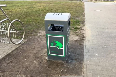 Trash Bin With Elephant Design Located in Park Near Bicycle Rack During Day.. Stock Photos