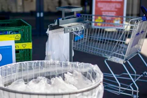 Trash bin full of used disposable wipes and plastic gloves at the entrance Stock Photos
