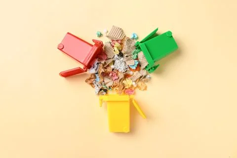 Trash bins and different garbage on color background, top view. Waste recycli Stock Photos