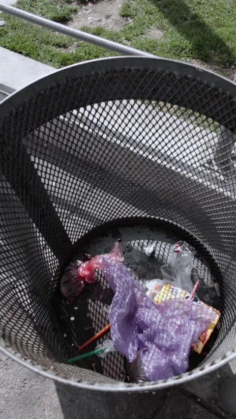 A trash can filled with a few plastic bags. Stock Footage 314912817