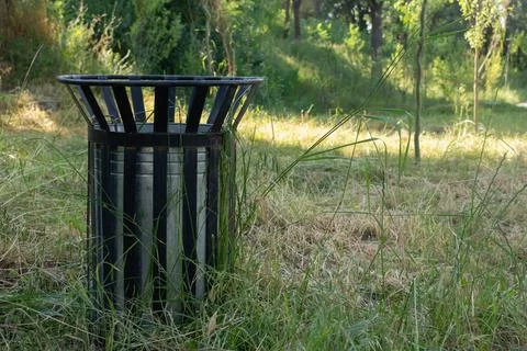 Trash can on grass background Stock Photos