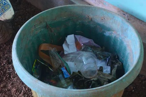 The trash can is inside the house and is full of plastic waste Stock Photos