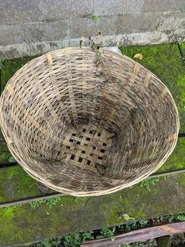 A trash can made of bamboo is in front of the house Stock Photos