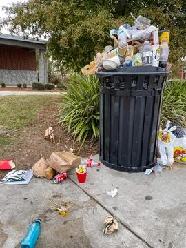 Trash can overflows with garbage at Georgia rest stop Stock Photos