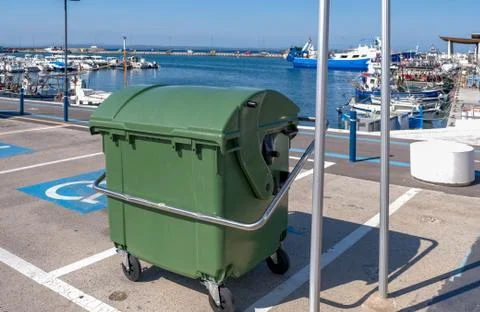Trash can in the port on the background of moored boats. Stock Photos