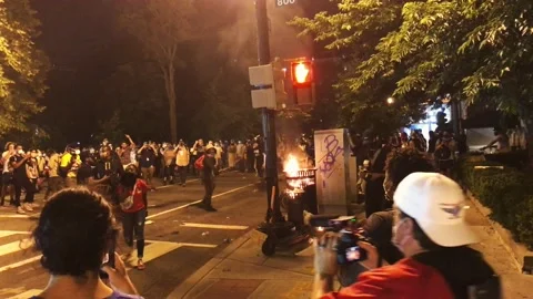 A trash can is set on fire at a Black Lives Matter protest in Washington, DC Stock Footage 131488008