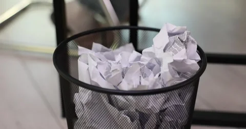 Trash can stands in office filled with discarded paper Stock Footage 270034007