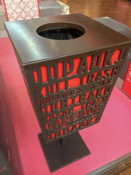 Trash can with text "Garbage" in different languages the shopping mall Stock Photos