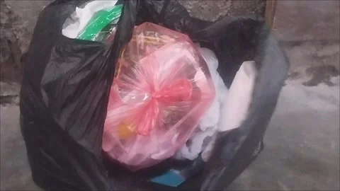 Trash Collected in Black Plastic Bag Stock Footage 296851263