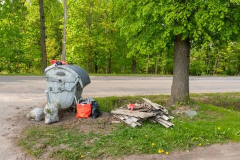 Trash container full with garbage along the road Stock Photos