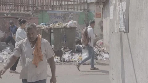 Trash containers overflowing with garbage in India; a man collecting trash Stock Footage 345390463