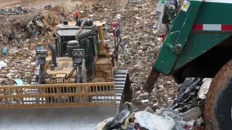 Trash Dropping from Truck While Dozer Pushes it Aside Stock Footage 55162065