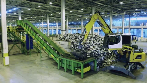 Trash, e-waste, electronic garbage recycling factory. Backhoe tractor moves Stock Footage 135660866